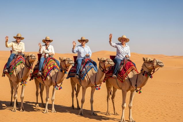 Elderly couple on a camel ride during Dubai desert safari